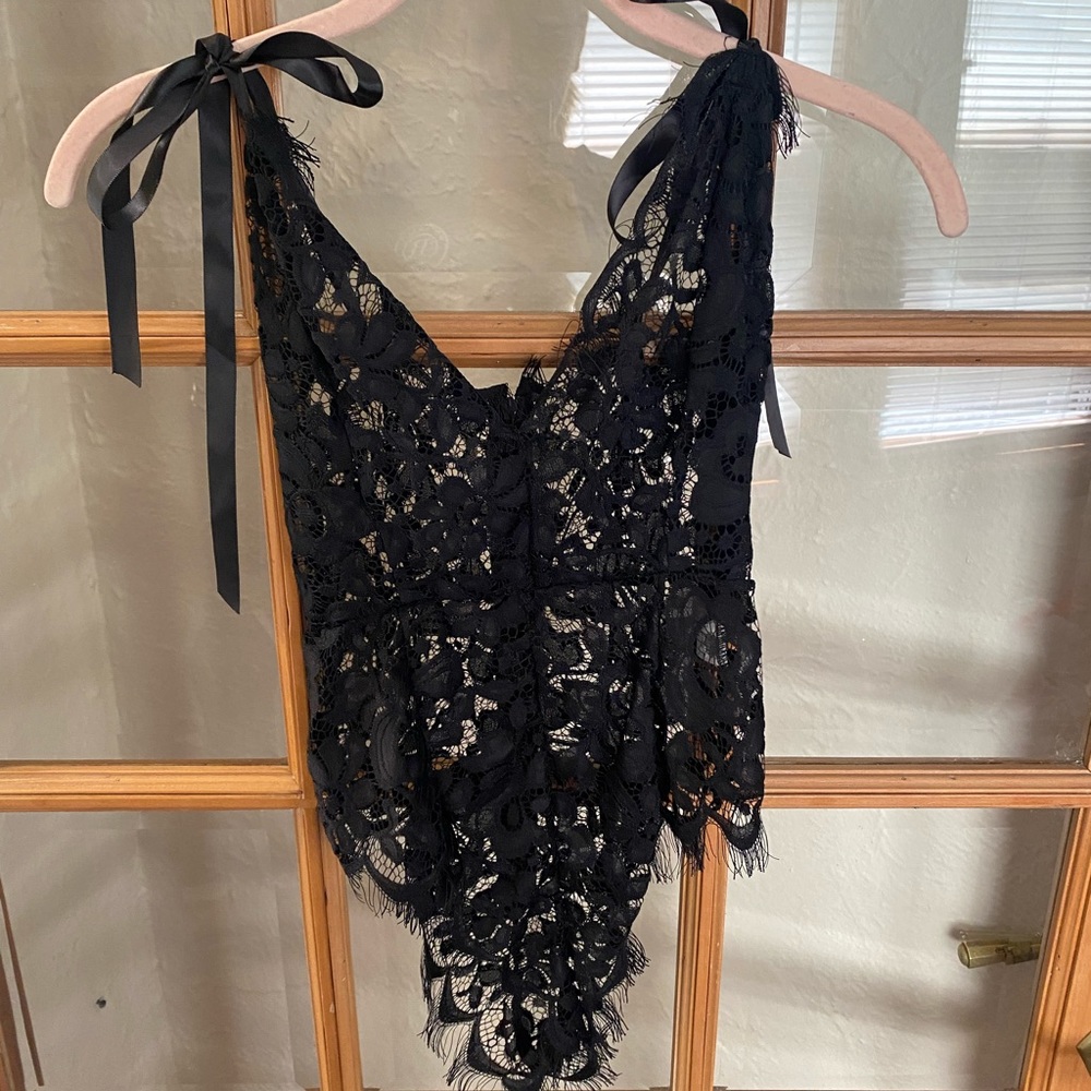 Lacey body suit with ties in the top size medium.